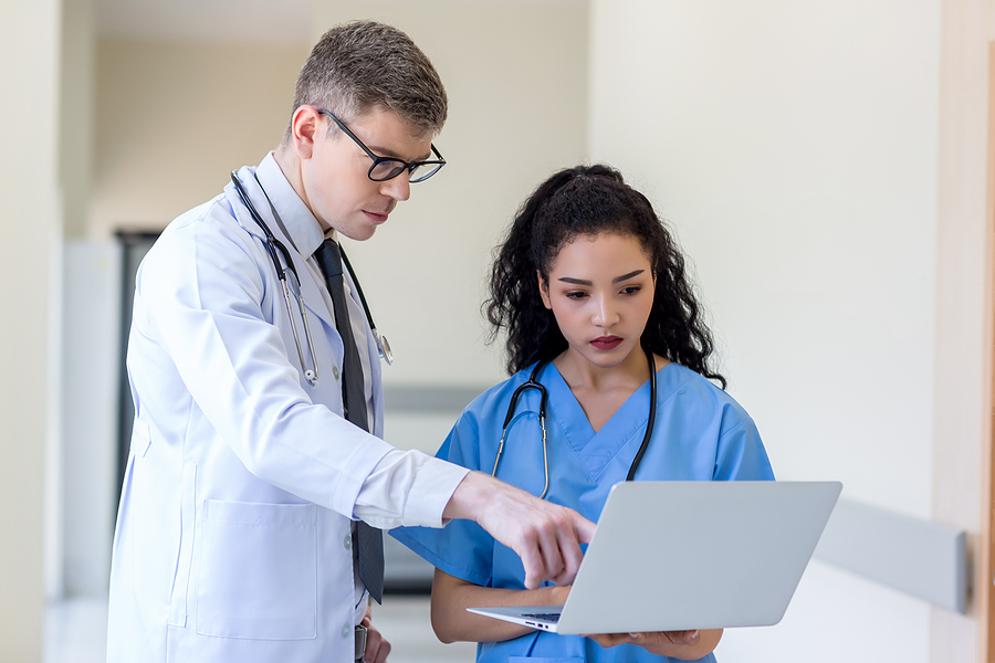 clinician talking with medical staff about medical malpractice